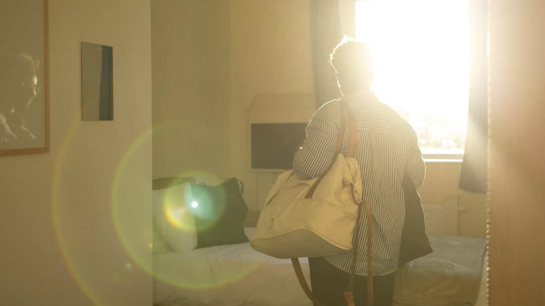 Woman entering a bedroom